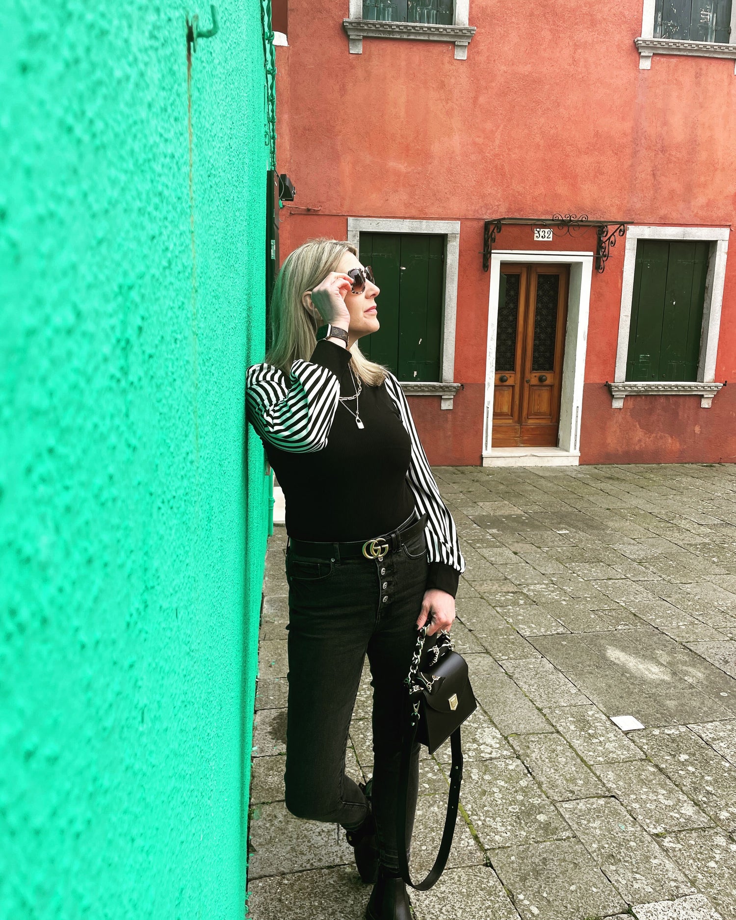 Robin standing against a wall